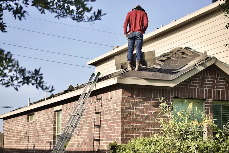 Professional roofer working on a residential roof in Weimertown
